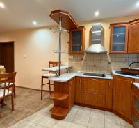A kitchen with wooden decor and a dining table in a 3-room apartment.