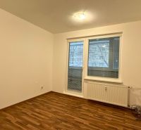 A room in a 3-room apartment with a wooden decor floor and a window with blinds.