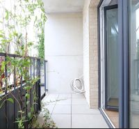 A balcony with plants in a studio apartment, opening to the exterior of Bratislava - Rača.
