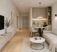 Living room in a studio apartment with wood-patterned flooring and neutral colors.