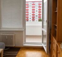 A room in a 3-room apartment with a wood-decor floor and a balcony.