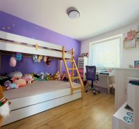 Children's room with a bunk bed and a wooden decor floor in a family house.