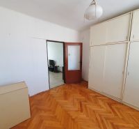 A room in a 3-room apartment with a wooden decor floor and a built-in wardrobe.