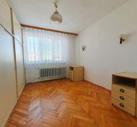 A room in a 3-room apartment with a floor featuring a wooden decor and white walls.