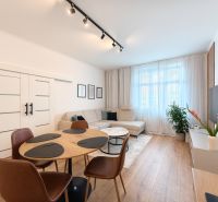 Living room with a corner sofa, dining table, and wooden decor flooring in a 3-room apartment.