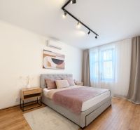 A bedroom in a 3-room apartment with a comfortable bed and a floor with a wooden decor.