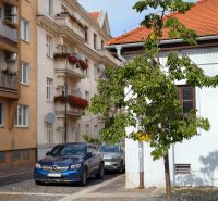 Vodná Street in Košice - Old Town with a tree and cars on the road.