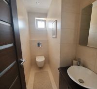 Bathroom in a 4-room apartment with a sink, toilet, and tiles in a subtle design.