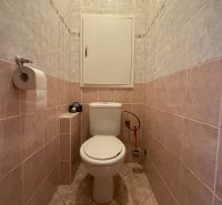 A toilet with ceramic tiles in a 4-room apartment.