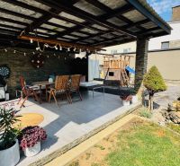 A terrace in a family house in Radobica with seating, a grill, and garden decorations.