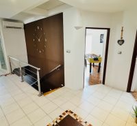 A hallway in a family house with modern decor and a foosball table.