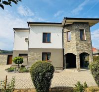 A family house in Radobica with stone cladding and a landscaped garden.