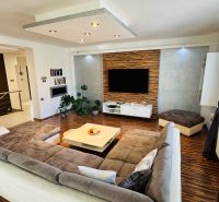 Living room with a comfortable sofa and wooden decor flooring in a family house.