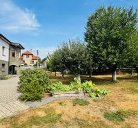 A family house in Radobica surrounded by a well-maintained garden with fruit trees.