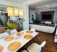 A dining room in a family house with elegant table settings and a wooden decor floor.