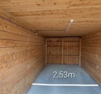 A closed space with a floor and walls with a wooden decor, width 2.53 meters.