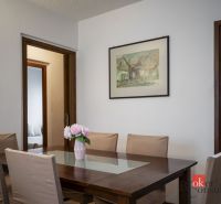 Dining room with a framed picture and a table with a vase, in a 4-room apartment.
