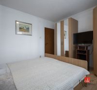 Bedroom in a 4-room apartment with a bed, wardrobe, and television.