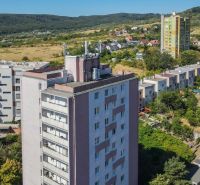 A view of residential buildings in Bratislava - Rača near Sadmelijská Street surrounded by greenery.