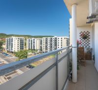 A balcony with a view of residential buildings in Bratislava - Rača on Sadmelijská, 3-room apartment.