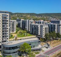 In Bratislava - Rača on Sadmelijská Street, you can see apartment complexes and greenery in the background.