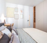 Bedroom with a built-in wardrobe, bed, and decor in a 3-room apartment.