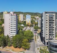 The view of the apartment buildings and greenery on Sadmelijská in Bratislava - Rača offers housing options.