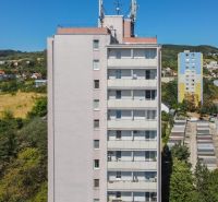 High-rise building on Sadmelijska Street in Bratislava - Rača, surrounded by nature and development.
