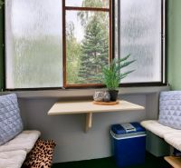 Cozy balcony with cushions and a table in a 2-room apartment.