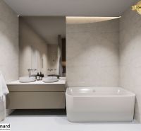 Bathroom of a 3-room apartment with a bathtub, two sinks, and a mirror on a light wall.