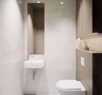A minimalist bathroom with a simple sink and toilet in a 3-room apartment.