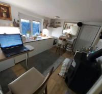 Kitchen in a family house with a work desk, kitchen furniture, and a stove.