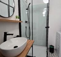 Bathroom interior with a shower and an elegant washbasin unit in a 3-room apartment.