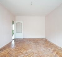 A room with a wooden decor floor in a 3-room apartment.