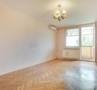 A room in a 3-room apartment with a wood-decor floor and a balcony.