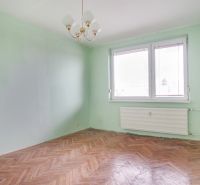 A room in a 3-room apartment with a wood-patterned floor and green walls.