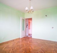 A room with a wooden floor decor and green walls in a 3-room apartment.