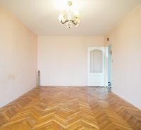 An empty room with a wooden decor floor in a 3-room apartment.