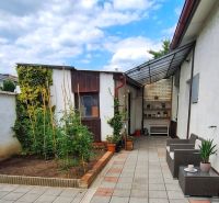 In Piešťany on Bodona Street, there is a courtyard of a family house with a terrace and plants.
