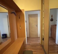 Interior of a 3-room apartment with a wooden decor floor and built-in wardrobes.