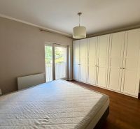 Bedroom in a 2-room apartment with a white wardrobe and a wooden decor floor.