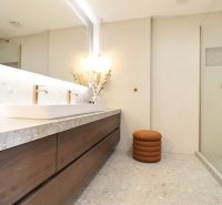 A bathroom with a double sink and a shower in a 3-room apartment.