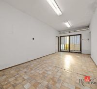 An empty room with windows and a wooden decor floor in a family house.