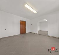 Interior of a family house with tiles and wooden doors, arched passage between rooms.