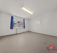 A spacious room with a window and curtains in a family house, tiled floor.