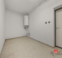 Empty room with a boiler and tiles in a family house.