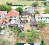 Family houses in Medzibrod surrounded by gardens and rural landscape.
