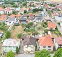Aerial view of family houses in Medzibrod surrounded by greenery and gardens.