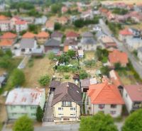Panoramic view of a family house in Medzibrod with surrounding buildings and greenery.