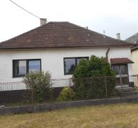 A family house in Trenčín with a white facade, a garden, and a sloped roof.